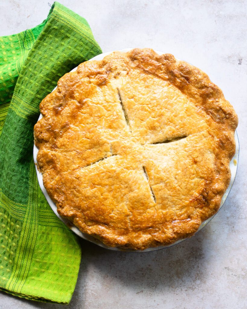 Looking down on a baked pie with four slits in the top.