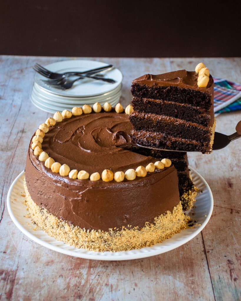 A cake server lifting a piece of chocolate nutella cake.