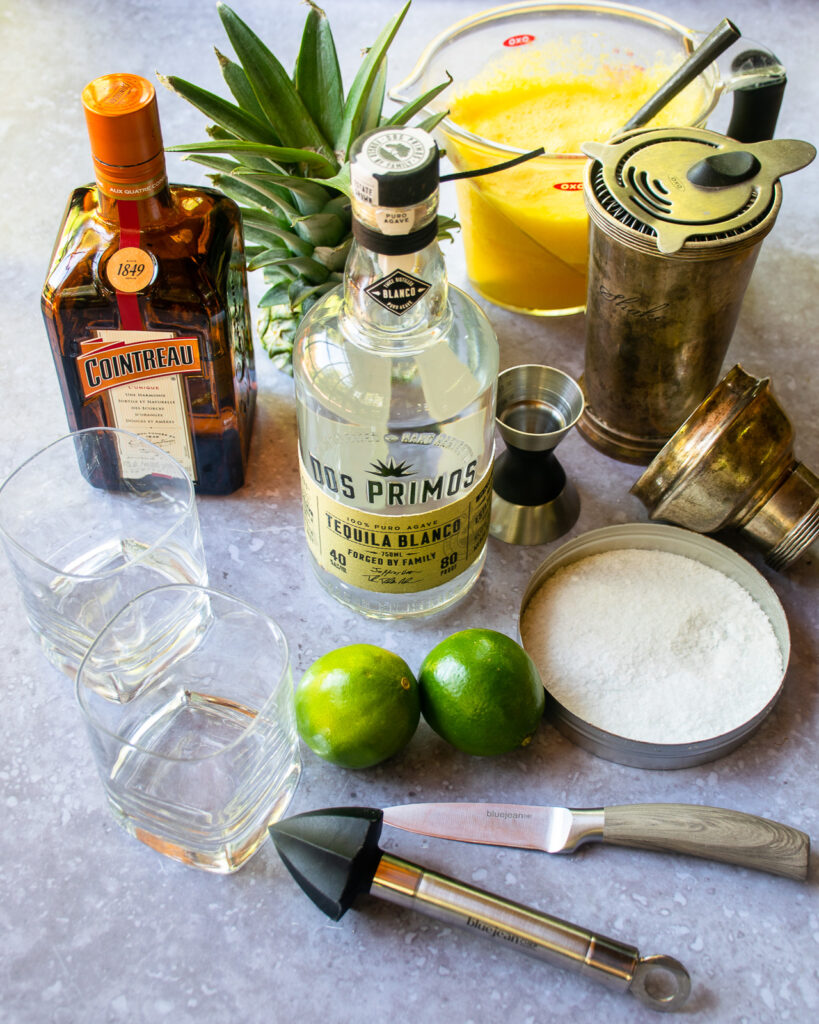 Ingredients for a pineapple margarita on a countertop.